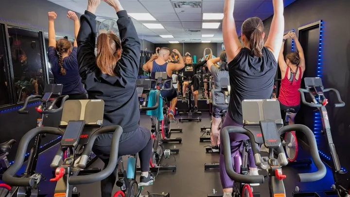 People using stationary bicycles in the Leisure Centre spin studio
