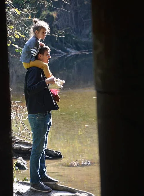 A child holds a salmon during the Kanaka Creek fish-fence event on October 21, 2018